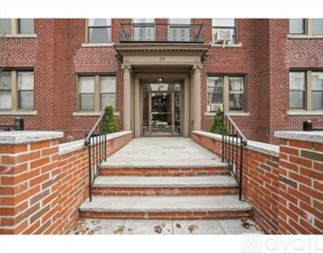 A brick building with a staircase leading to the entrance.