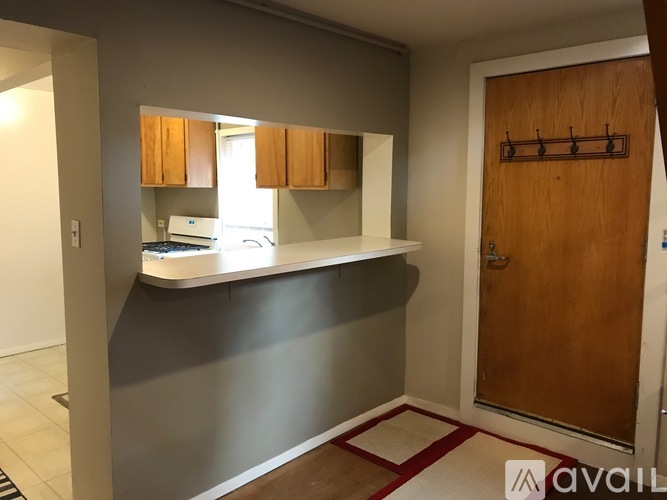 A kitchen area with a countertop and cabinets.