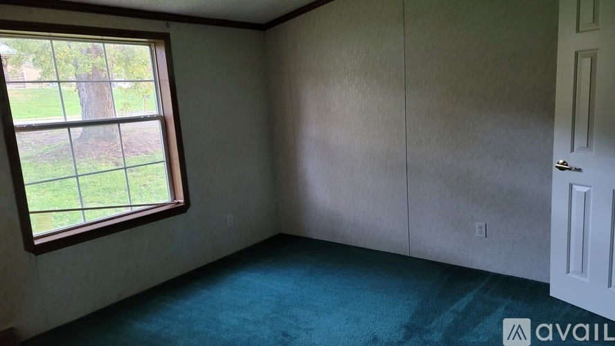A room with a window and a door.
