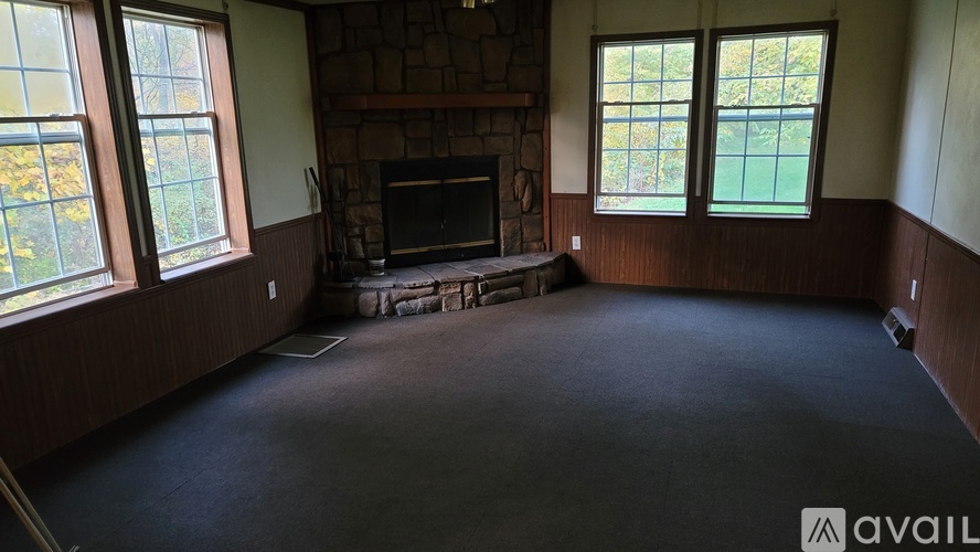 A living room with a fireplace and a flat screen TV.
