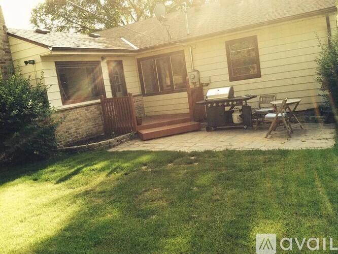 A house with a patio and a grill.