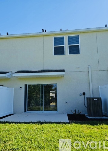 A modern house with a white exterior and a glass door.