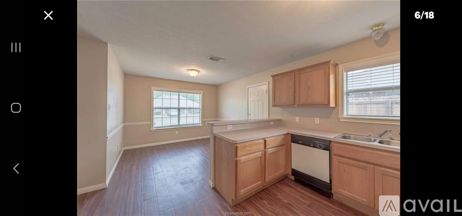 A kitchen with wooden cabinets and a window.