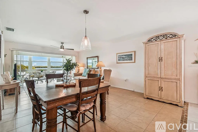 A dining room with a wooden table and chairs.
