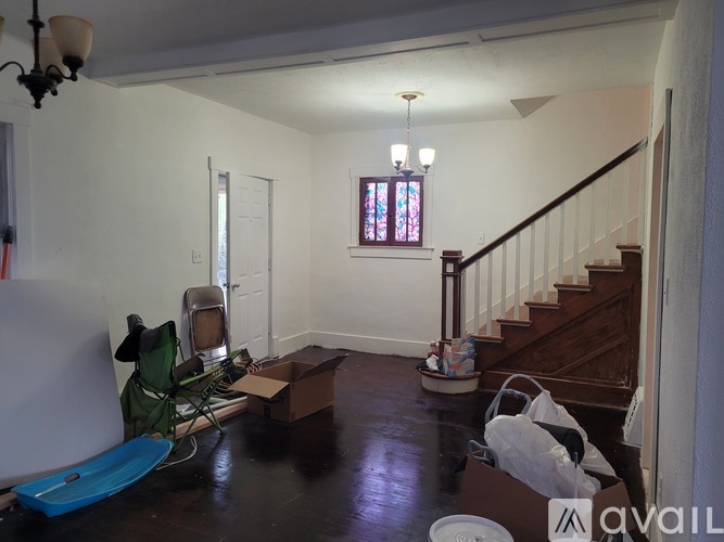 A room with a staircase and a box on the floor.