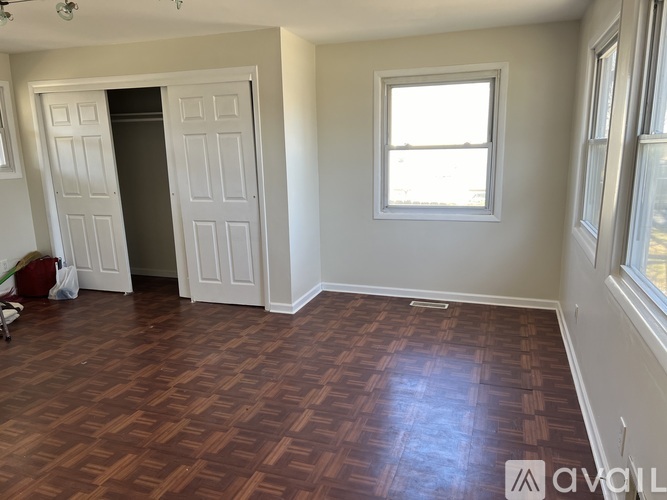 A room with a wooden floor and a window.