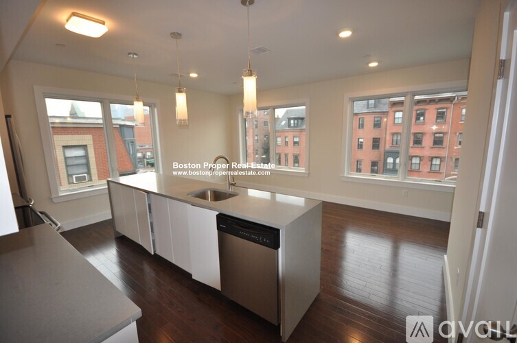 A kitchen with a stainless steel dishwasher and a sink.