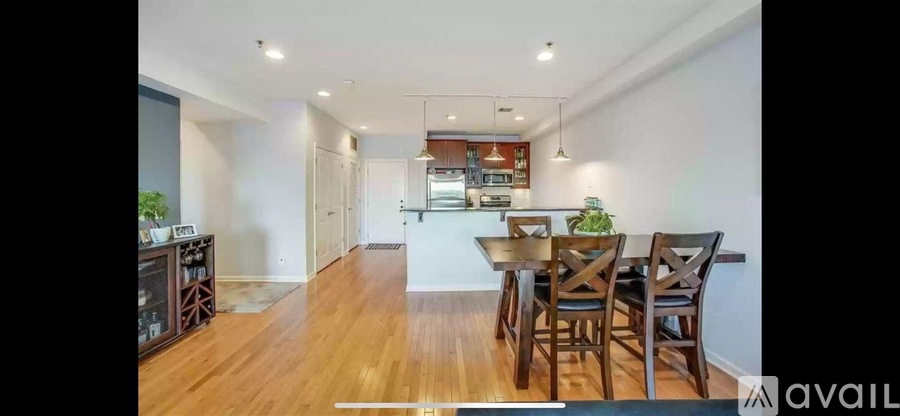 A dining area with a wooden table and chairs.