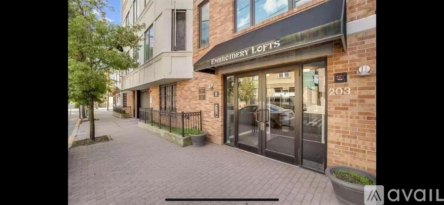 The exterior of a brick building with a sign that reads "Embassy Lofts.".