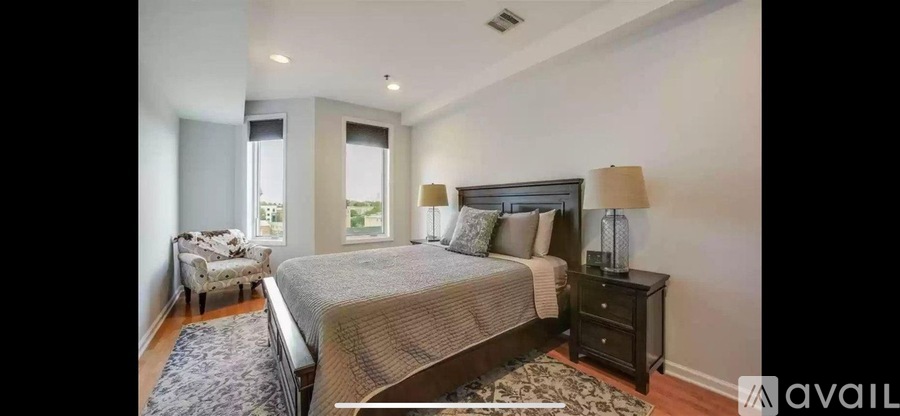 A bedroom with a large bed and a window with a view.