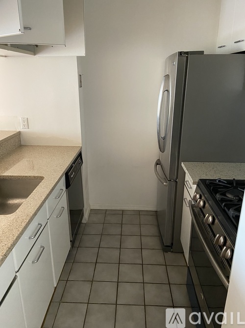 A kitchen with a refrigerator, stove, and oven.