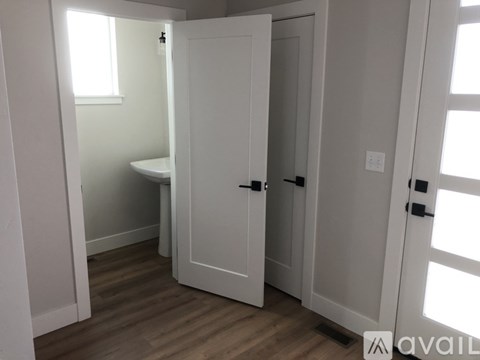 A small bathroom with a toilet and a door.
