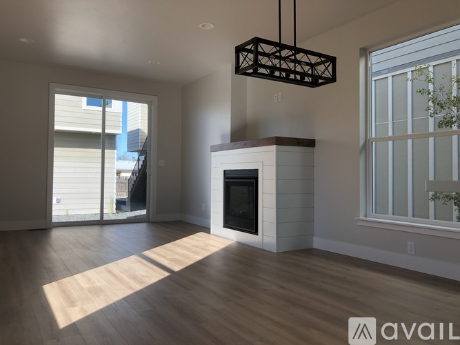 A modern living room with a fireplace and sliding glass doors.