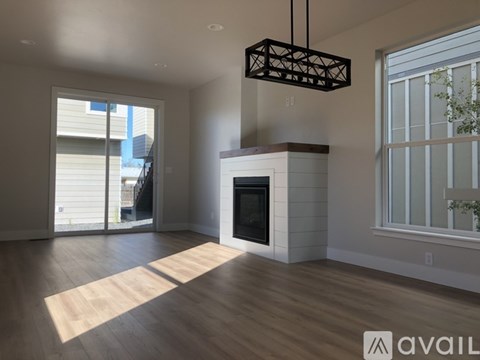 A modern living room with a fireplace and sliding glass doors.