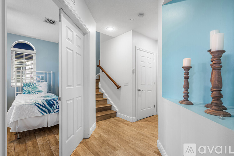 A bedroom with a bed and a staircase.