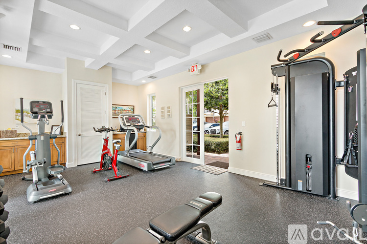A gym with a variety of equipment including treadmills, stationary bikes, and weight machines.