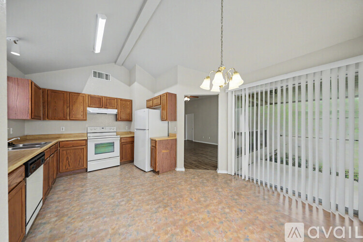 A kitchen with wooden cabinets and a white refrigerator.