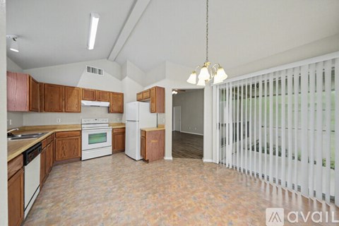 A kitchen with wooden cabinets and a white refrigerator.