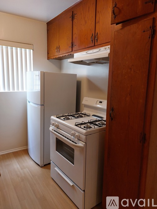 A kitchen with a stove, oven, and refrigerator.