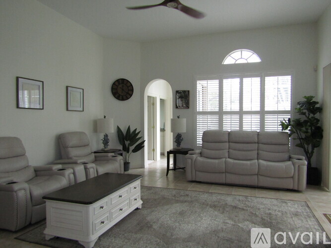 A living room with a couch, chair, and table.