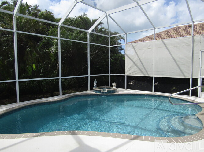 A small pool with a white fence surrounding it.