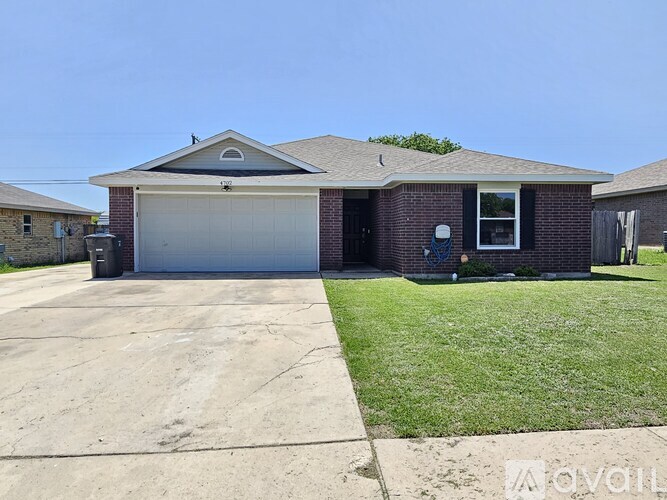 A house with a garage and a driveway in front.