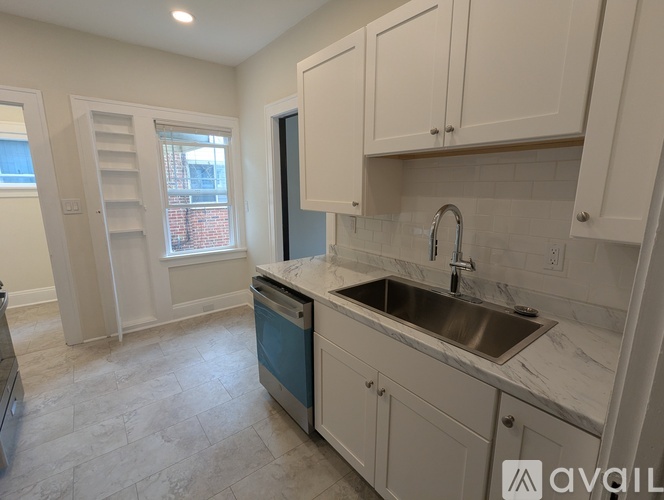A kitchen with a sink and cabinets.
