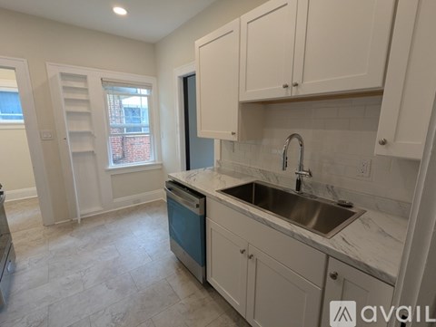 A kitchen with a sink and cabinets.