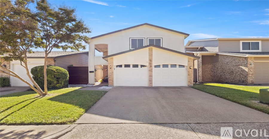 A house with a garage is for sale.