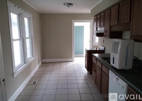 A kitchen with a white microwave on the counter.
