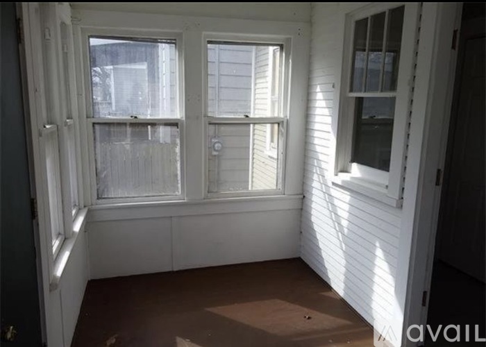A room with two windows and a door.