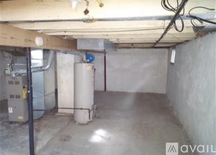 A basement with a furnace and a water heater.