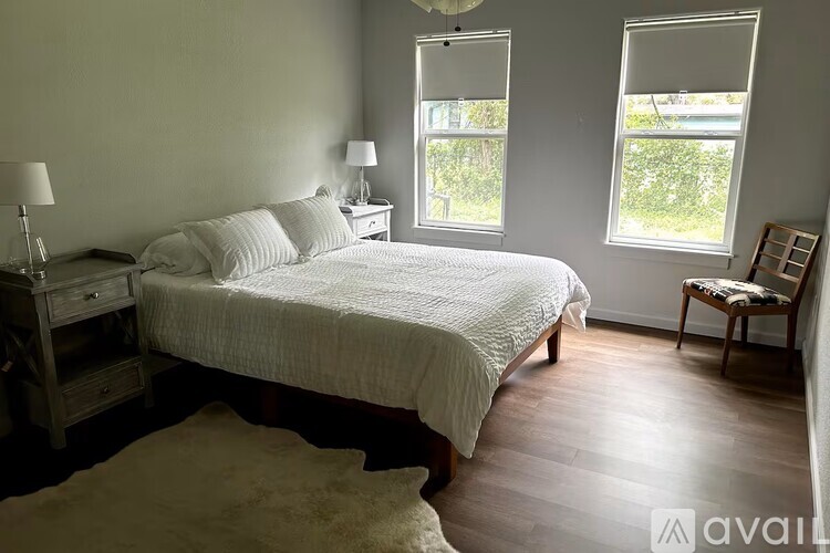 A bedroom with a large bed and a window.