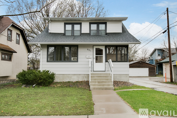 A house with a front yard and a driveway.