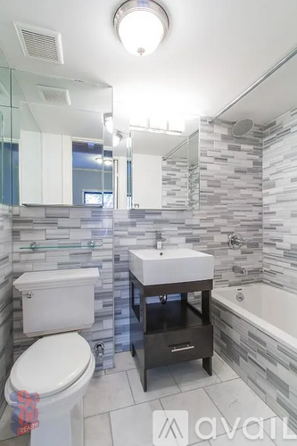 A bathroom with a toilet, sink, and a bathtub.