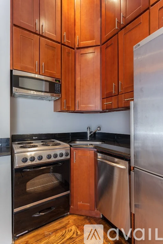 A kitchen with wooden cabinets and stainless steel appliances.