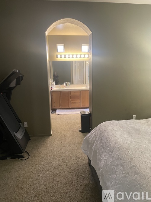 A bedroom with a large bed and a TV.