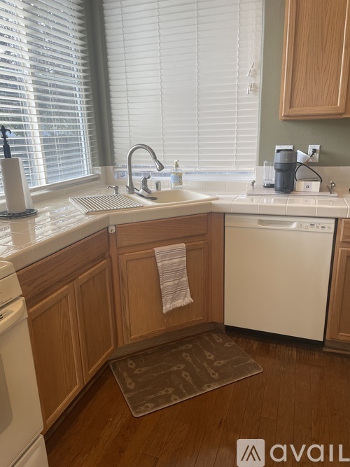 A kitchen with wooden cabinets and white appliances.