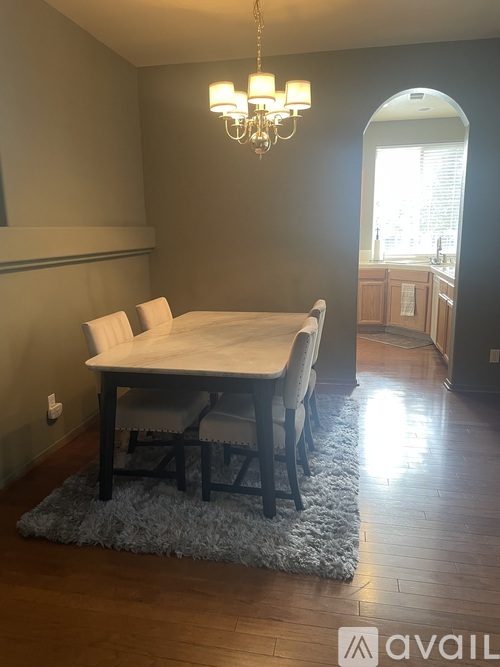 A dining room with a table and chairs.