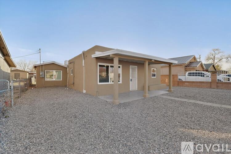A house with a gravel driveway is for sale.