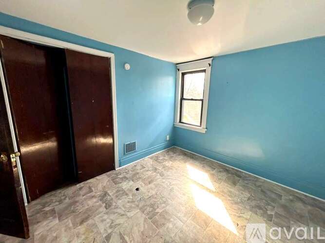 A room with blue walls and a window.