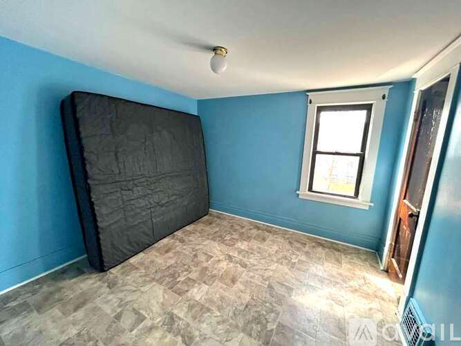A room with blue walls and a grey carpet.