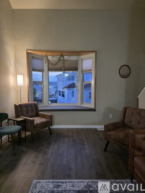 A living room with a brown chair and a green table.