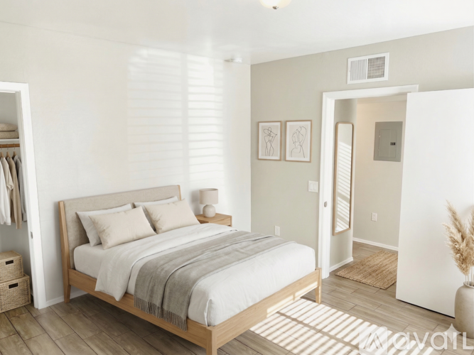 A bedroom with a large bed and a striped rug.