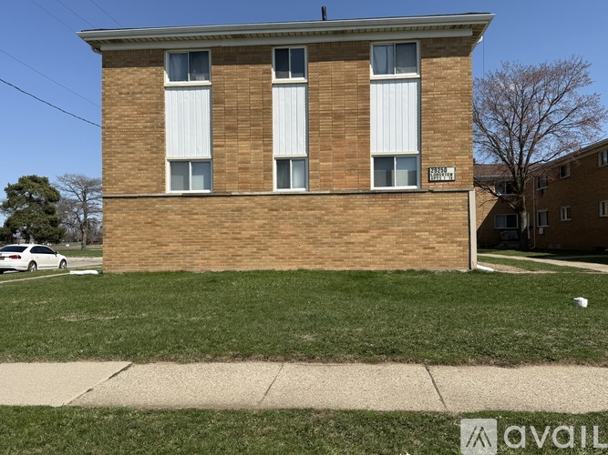 A brick building with a sign that says "AVAILABLE" on the front.