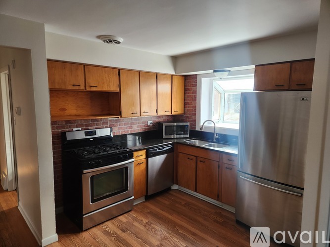 A kitchen with wooden cabinets and stainless steel appliances.