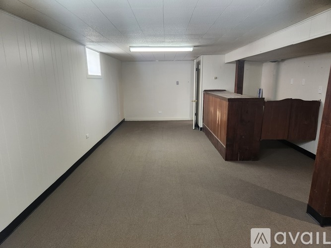 A room with a carpeted floor and white walls.