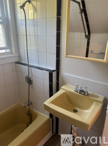 A bathroom with a yellow tub and sink.