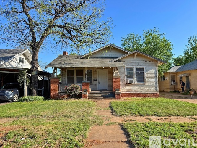 A house with a tree in front of it.
