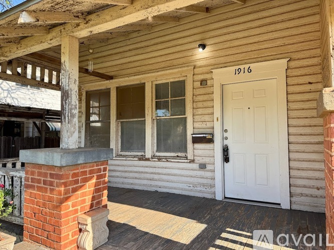 A wooden house with a white door and windows.